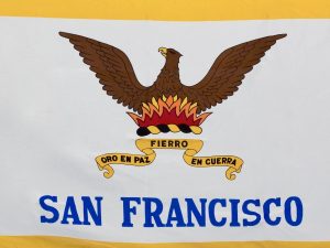 The San Francisco Flag - This photo captures the San Francisco city flag in detail, highlighting its bold colors and symbolism. The phoenix represents the city's ability to overcome adversity, while the fire signifies its passion and determination. The Spanish motto "Oro en Paz. Fierro en Guerra" translates to "Gold in Peace. Iron in War," reflecting San Francisco's commitment to prosperity and resilience. This flag is a symbol of city pride and a popular souvenir for visitors.